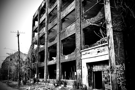 The face of an abandoned brick building.